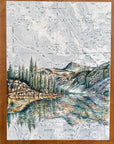 a close-up of the wallowas mirror lake eagle cap final switchback original painting in a wooden frame by artist Katie Jeanne Ream