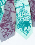 close-up of two final switchback cotton bandanas in backcountry mint and purple featuring artist Katie Jeanne Reim's prints