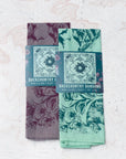 two final switchback cotton bandanas in backcountry mint and purple featuring artist Katie Jeanne Reim's prints