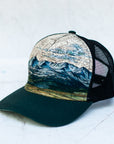 angle view of the final switchback trucker hat featuring artist Katie Jeanne Reim's Bridger print