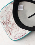 brim view of the final switchback trucker hat featuring artist Katie Jeanne Reim's Broken Top print