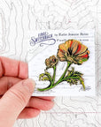 final switchback poppy enamel pin on holder created by artist Katie Jeanne Reim