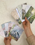 a hand holding final switchback's greeting cards featuring contours of national parks prints by artist Katie Jeanne Reim