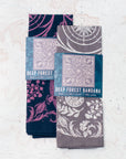 two final switchback cotton bandanas in Deep Forest wildberry and stone featuring artist Katie Jeanne Reim's prints