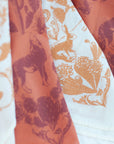 close-up of two final switchback cotton bandanas in Desert Nights cream and orange featuring artist Katie Jeanne Reim's prints