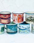 The full collection of final switchback fireproof enamel mugs featuring artist Katie Jeanne Reim's prints