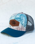 angle view of the final switchback trucker hat featuring artist Katie Jeanne Reim's Glacier Goat Summit print