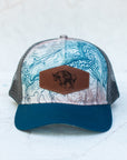 front view of the final switchback trucker hat featuring artist Katie Jeanne Reim's Glacier Goat Summit print