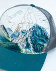 front angle view of the final switchback trucker hat featuring artist Katie Jeanne Reim's Glacier Grinnell print