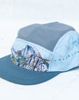 angle view of the final switchback 5-panel trail hat featuring artist Katie Jeanne Reim's half-dome print