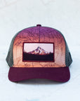 front view of the final switchback trucker hat featuring artist Katie Jeanne Reim's mount hood sunset print