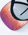 brim view of the final switchback trucker hat featuring artist Katie Jeanne Reim's mount hood sunset print
