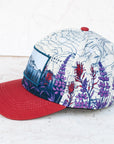 side view of the final switchback twill hat featuring artist Katie Jeanne Reim's Mount Rainier Meadow print