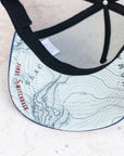 Brim view of the final switchback trucker hat featuring artist Katie Jeanne Reim's Mount Rainier Summit print