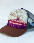 angle view of the final switchback trucker hat featuring artist Katie Jeanne Reim's Mount Rainier Sunset print