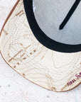 brim view of the final switchback trucker hat featuring artist Katie Jeanne Reim's Mount Rainier Sunset print
