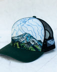 angle view of the final switchback trucker hat featuring artist Katie Jeanne Reim's Mount Rainier Tatoosh print