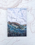 a final switchback button magnet featuring Katie Jeanne Reim's cascade pass print