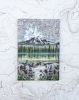 a final switchback button magnet featuring Katie Jeanne Reim's mount rainier reflections print