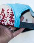 back view of the final switchback 5-panel trail hat featuring artist Katie Jeanne Reim's Paintbrush print