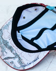brim view of the final switchback 5-panel trail hat featuring artist Katie Jeanne Reim's Paintbrush print