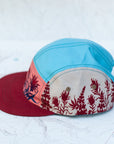 side view of the final switchback 5-panel trail hat featuring artist Katie Jeanne Reim's Paintbrush print
