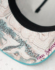 brim view of the final switchback trucker hat featuring artist Katie Jeanne Reim's teton print