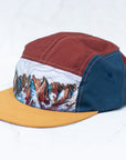 angle view of the final switchback 5-panel trail hat featuring artist Katie Jeanne Reim's Picket Range print