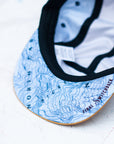 brim view of the final switchback 5-panel trail hat featuring artist Katie Jeanne Reim's Picket Range print