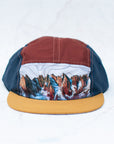 Front view of the final switchback 5-panel trail hat featuring artist Katie Jeanne Reim's Picket Range print