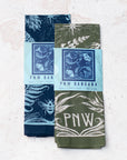 two final switchback cotton bandanas in PNW Green and PNW blue featuring artist Katie Jeanne Reim's prints