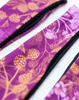 a close-up of final switchback quick dry headband sfeaturing artist Katie Jeanne Reim's Wildberry print