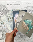 a hand holding final switchback's greeting cards featuring taste of Portland prints by artist Katie Jeanne Reim