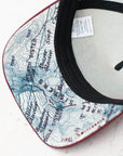 brim view of the final switchback trucker hat featuring artist Katie Jeanne Reim's three sisters print