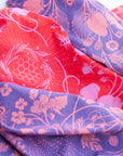 a close-up of two final switchback cotton bandanas in wildberry red and wildberry purple featuring artist Katie Jeanne Reim's prints