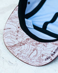 Brim view of the final switchback trucker hat featuring artist Katie Jeanne Reim's Zion print
