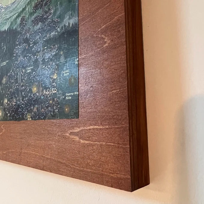 a close-up of the wooden frame holding a final switchback original painting by artist Katie Jeanne Ream