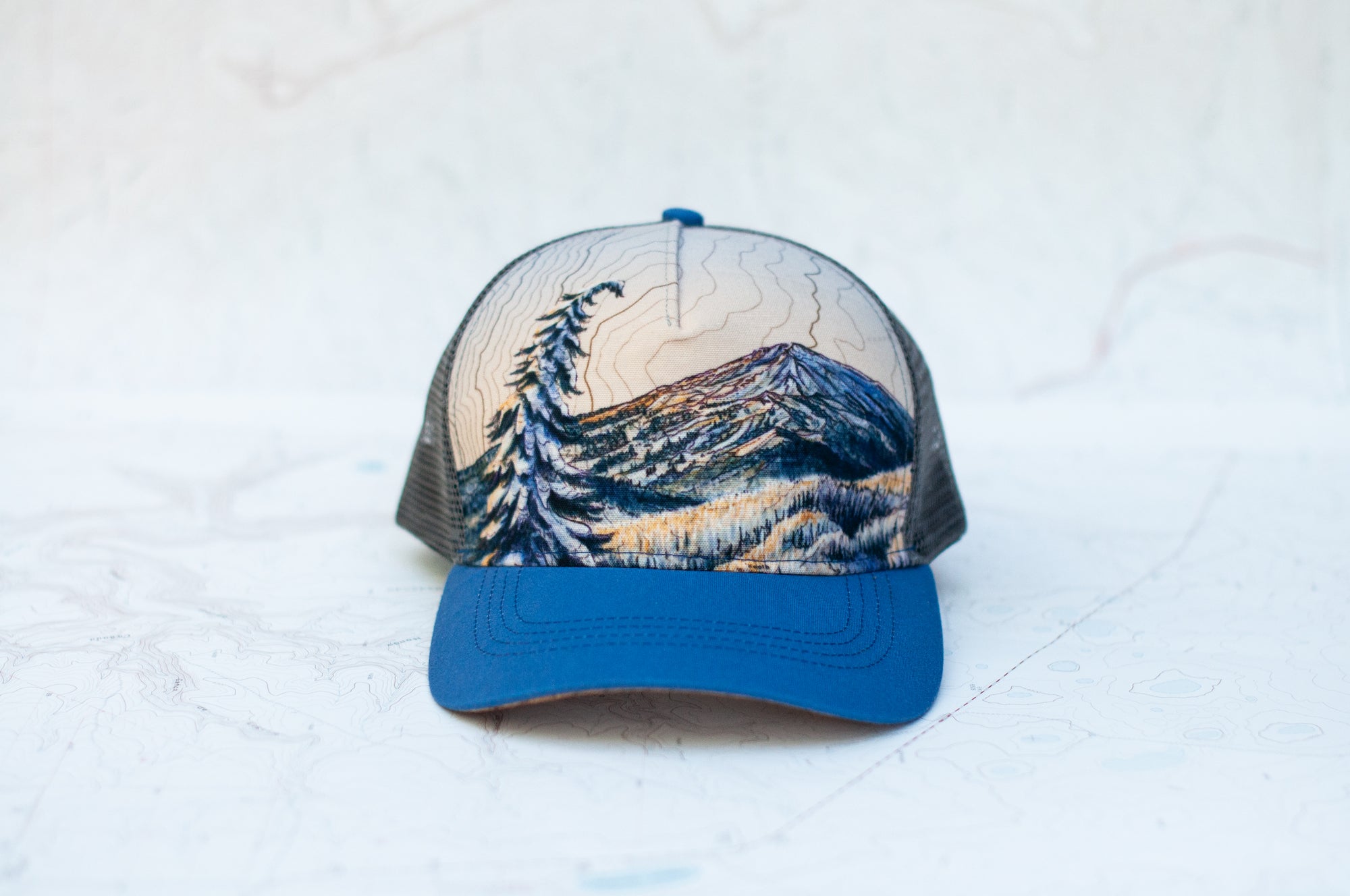 front view of the final switchback trucker hat featuring artist Katie Jeanne Reim's Bachelor print
