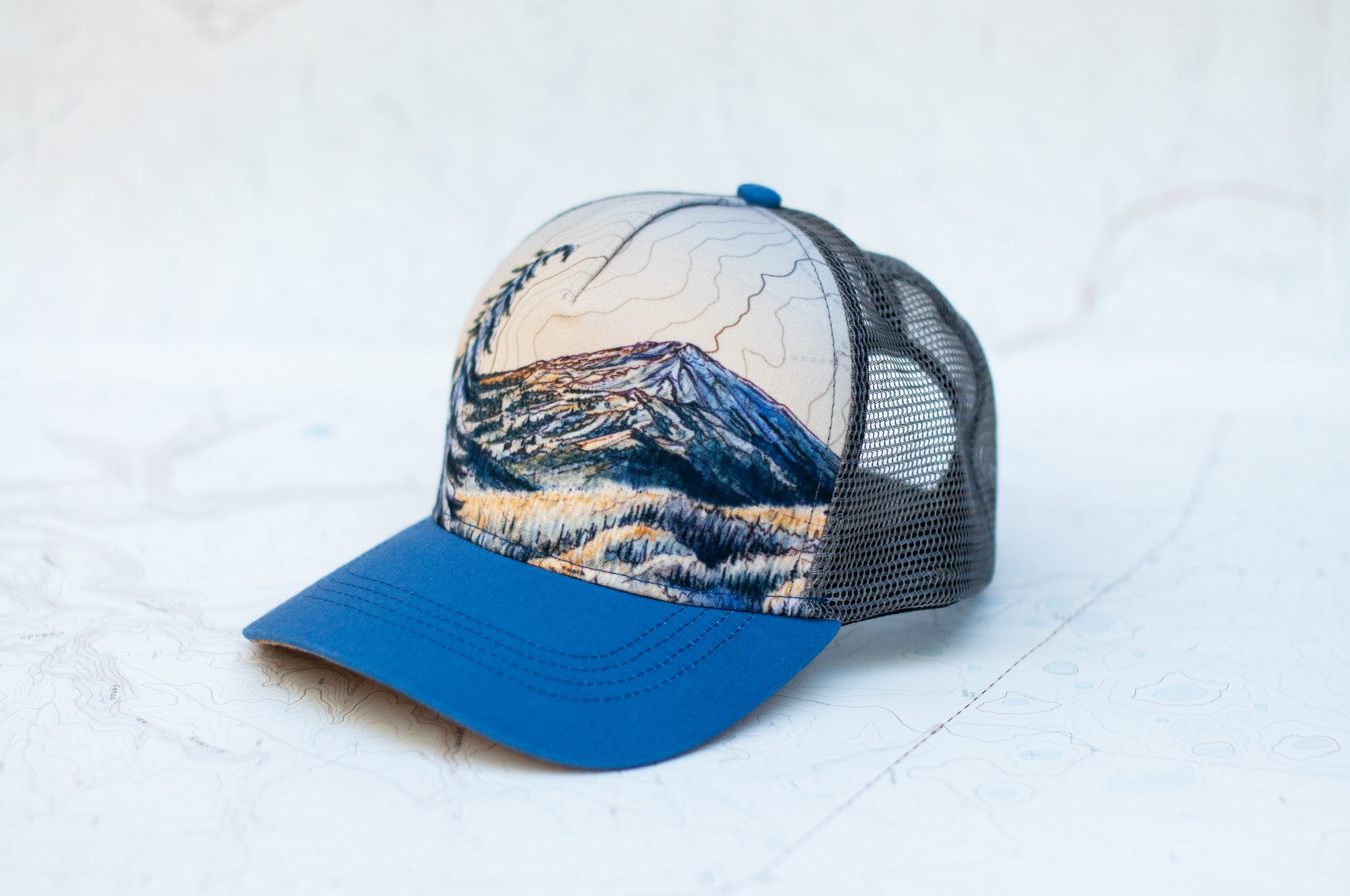 angle view of the final switchback trucker hat featuring artist Katie Jeanne Reim's Bachelor print