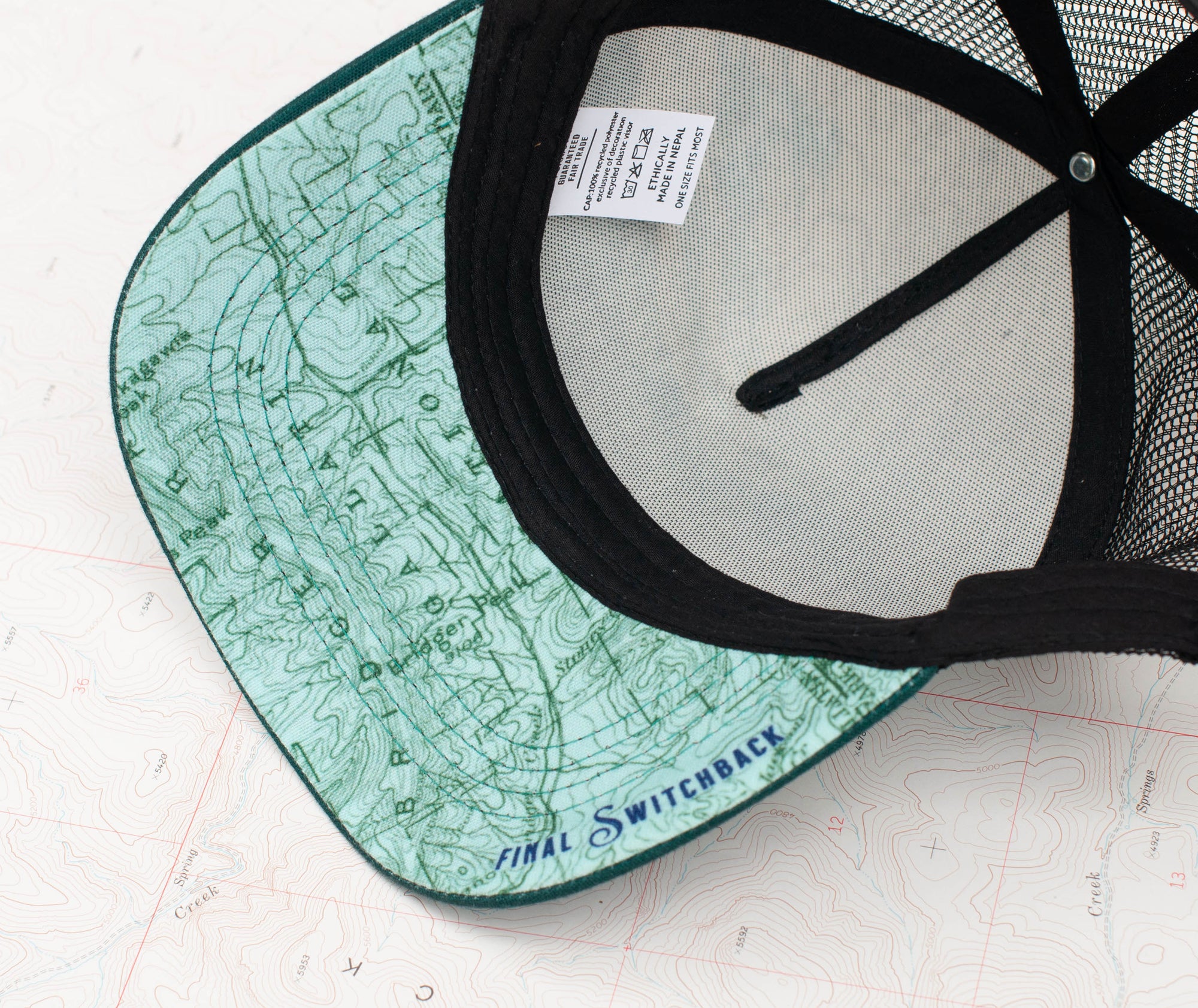 brim view of the final switchback trucker hat featuring artist Katie Jeanne Reim&#39;s Bridger print