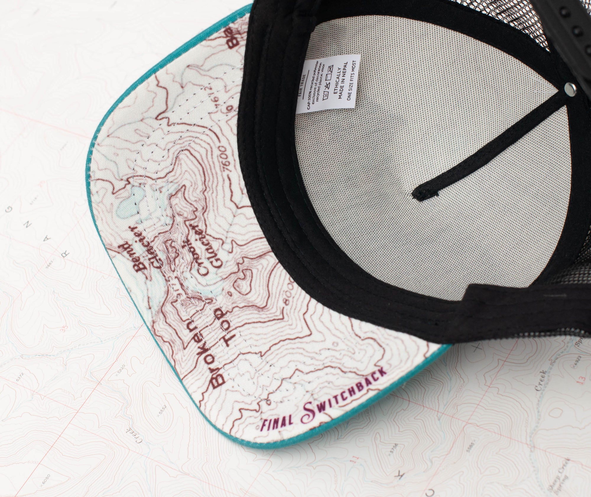 brim view of the final switchback trucker hat featuring artist Katie Jeanne Reim&#39;s Broken Top print