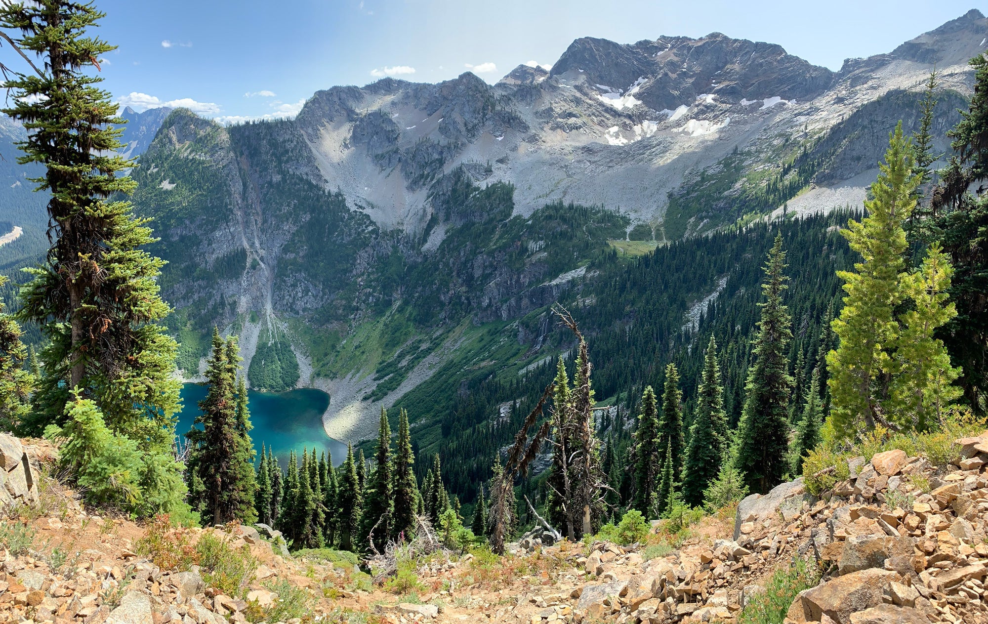 a photo of a nature scene of mountains and a lake in the middle of a forest taken by artist Katie Jeanne Reim