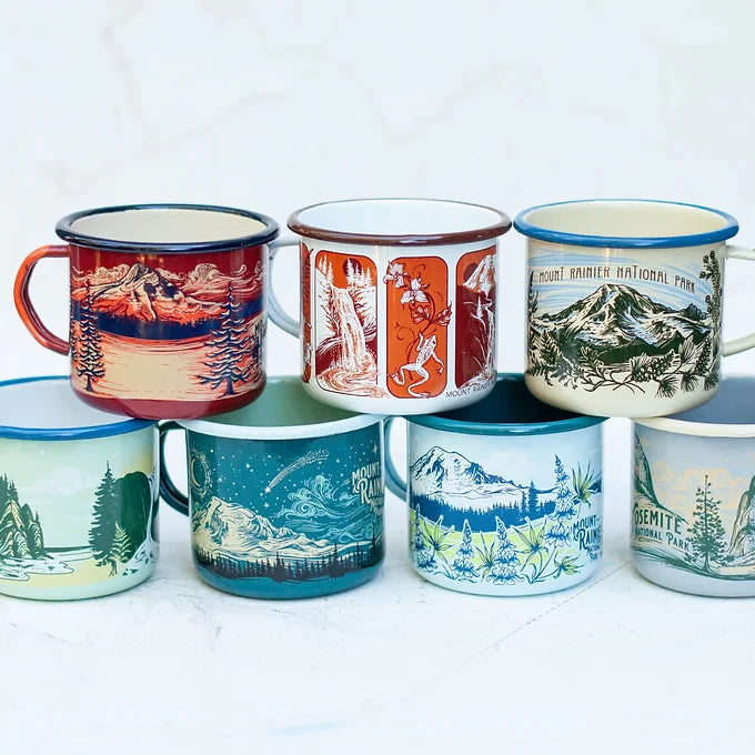 The full collection of final switchback fireproof enamel mugs featuring artist Katie Jeanne Reim's prints