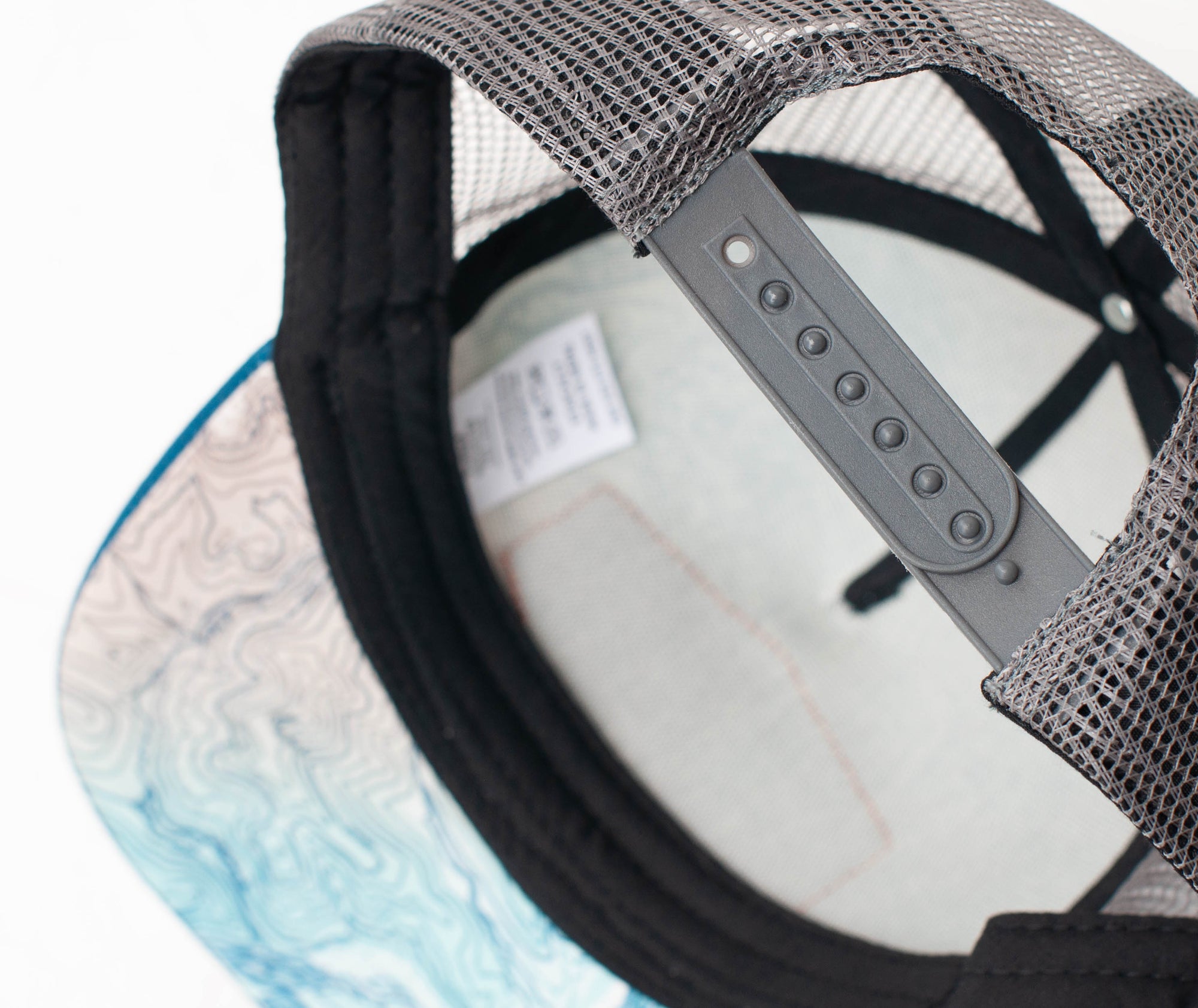 brim view of the final switchback trucker hat featuring artist Katie Jeanne Reim&#39;s Glacier Goat Summit print