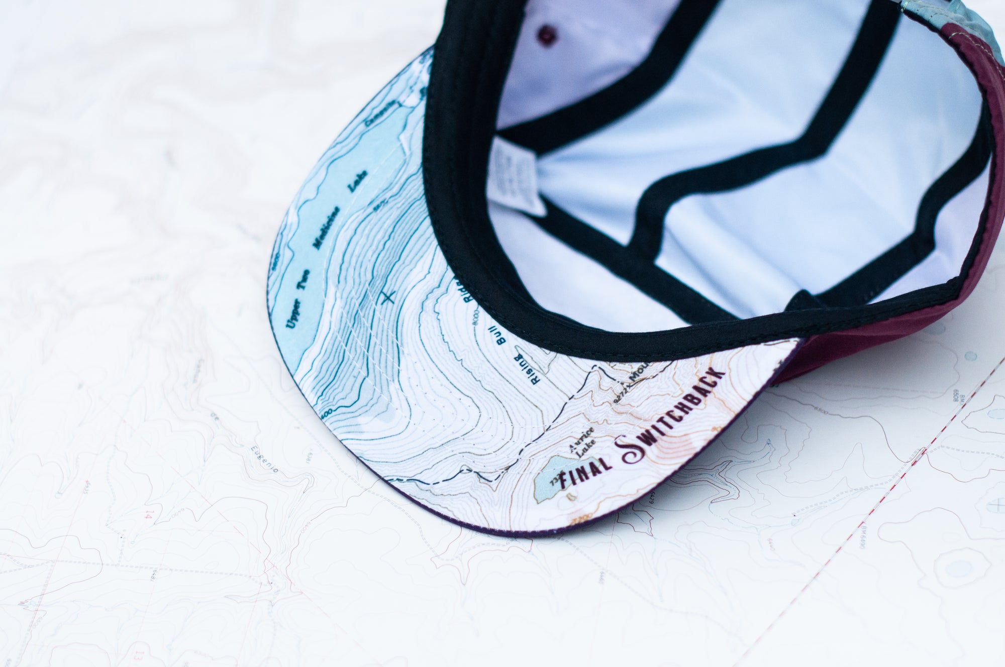 brim view of the final switchback 5-panel trail hat featuring artist Katie Jeanne Reim&#39;s Glacier Two Medicine print