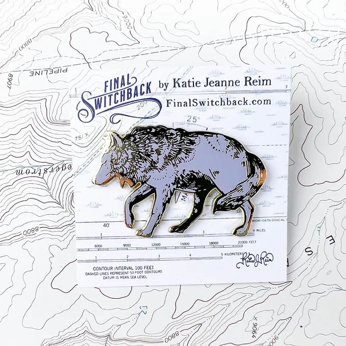 final switchback grey wolf enamel pin on holder created by artist Katie Jeanne Reim