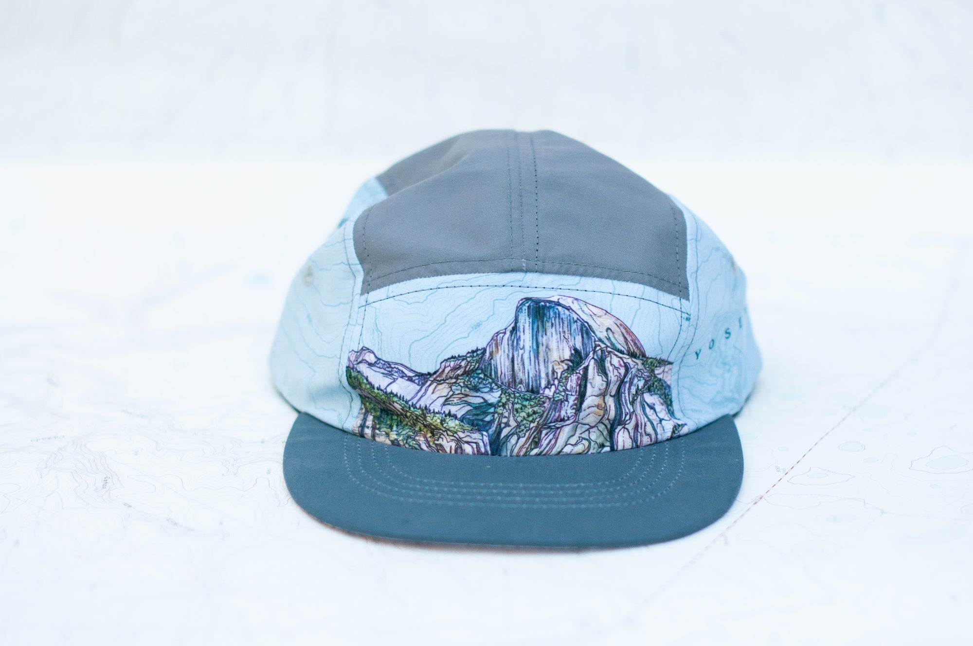 front view of the final switchback 5-panel trail hat featuring artist Katie Jeanne Reim&#39;s half-dome print