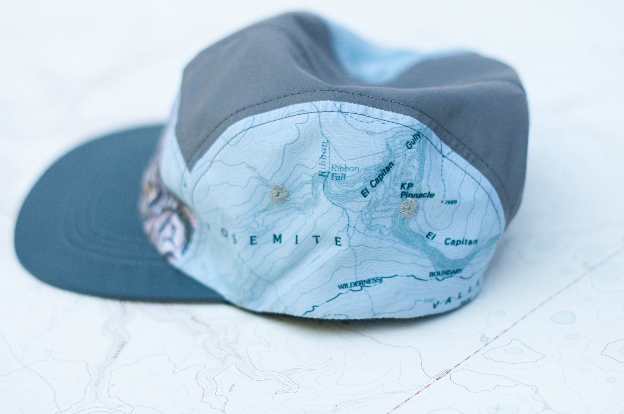 left side view of the final switchback 5-panel trail hat featuring artist Katie Jeanne Reim&#39;s half-dome print