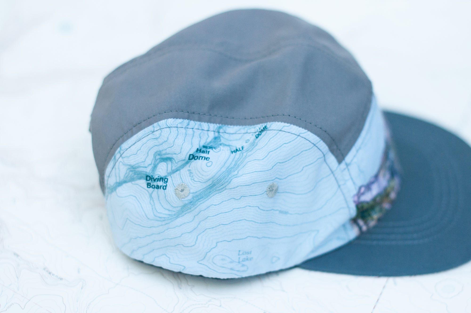 side view of the final switchback 5-panel trail hat featuring artist Katie Jeanne Reim&#39;s half-dome print