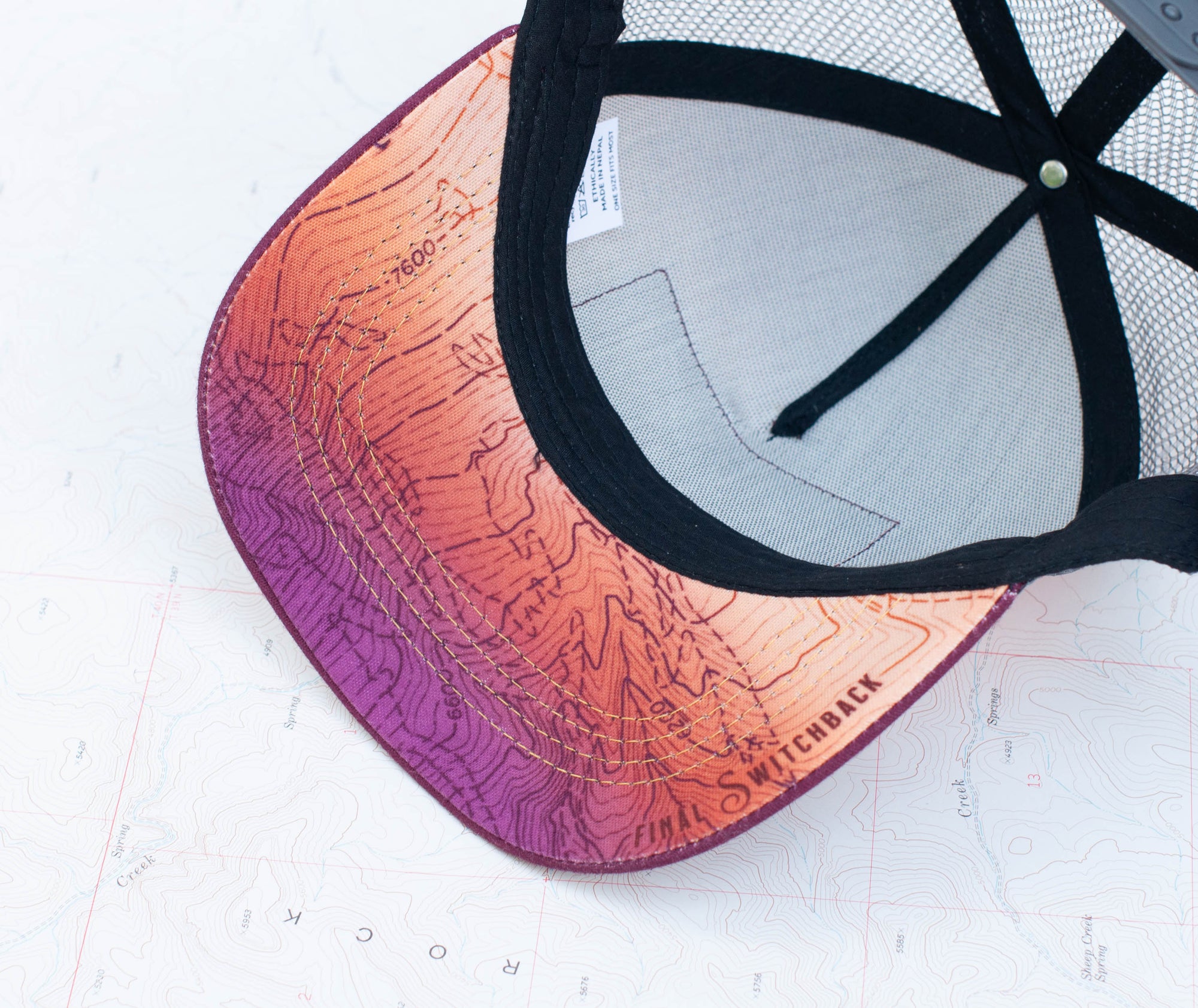 brim view of the final switchback youth trucker hat featuring artist Katie Jeanne Reim's Mount Hood Sunset print